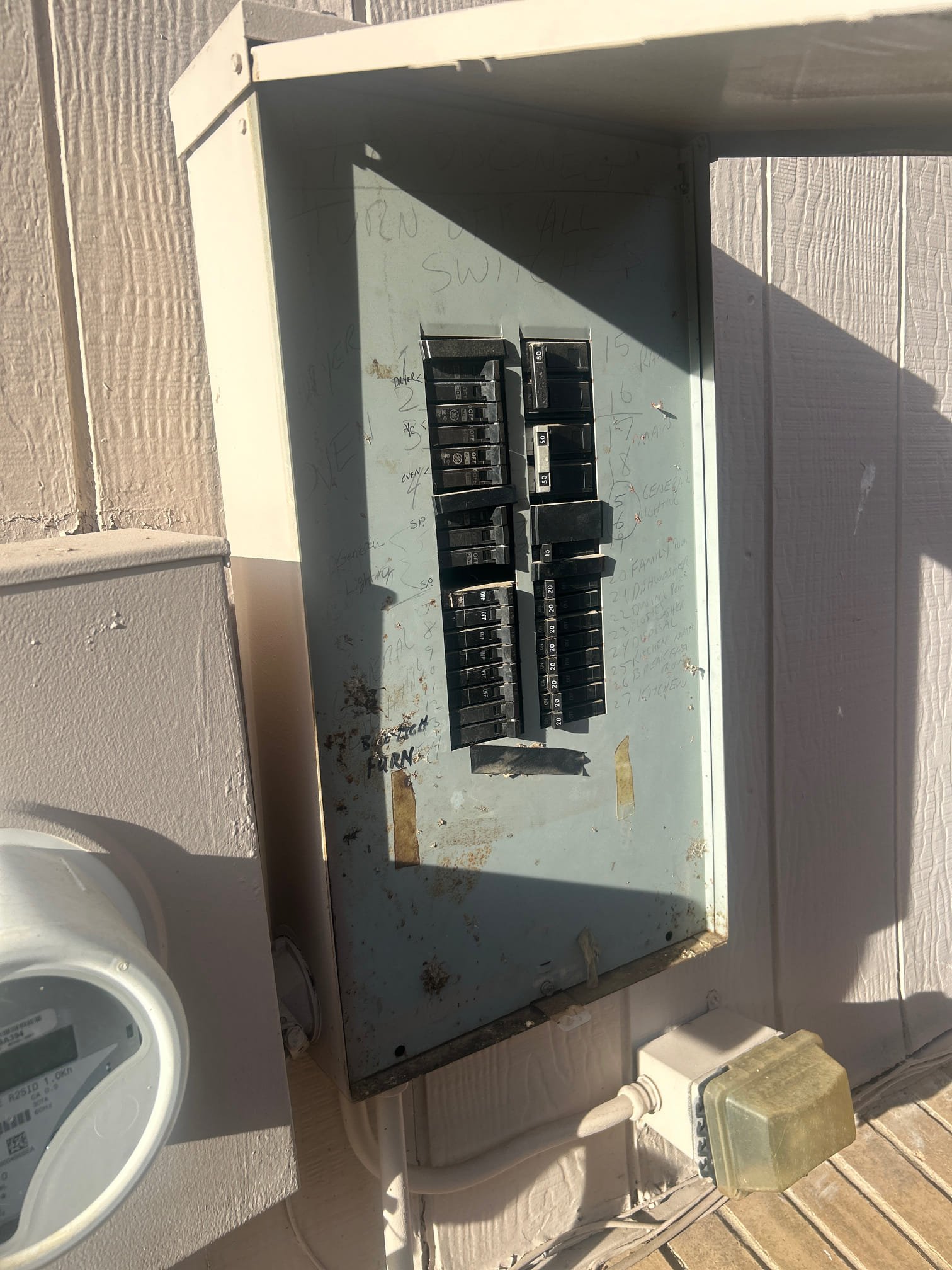 Older electrical panel before an upgrade for EV charging
